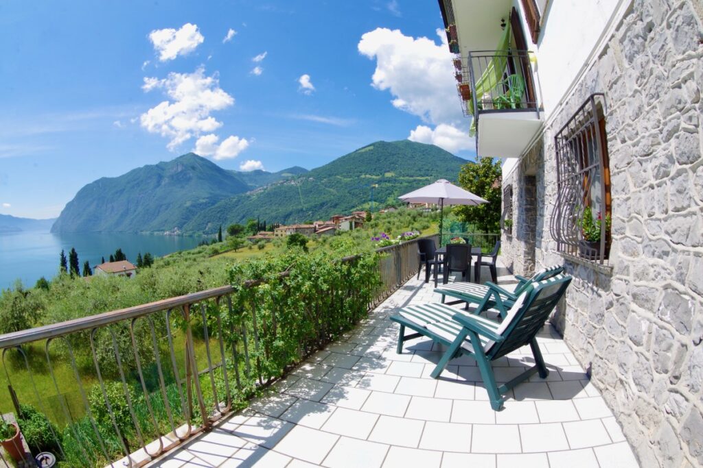 Terrace with deckchairs overlooking the lake and surrounding mountains